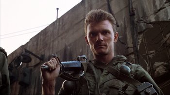 Movie still from “Full Metal Jacket” (1987), directed by Stanley Kubrick – A person holding a gun; Close Up shot, Low angle