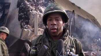 Movie still from “Full Metal Jacket” (1987), directed by Stanley Kubrick – A man in a military uniform is talking into a microphone; Close Up shot, Low angle
