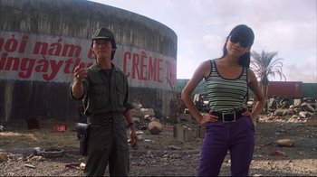 Movie still from “Full Metal Jacket” (1987), directed by Stanley Kubrick – A man and a woman standing in front of a cement wall; Medium shot, Low angle
