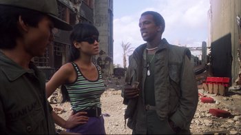 Movie still from “Full Metal Jacket” (1987), directed by Stanley Kubrick – A man and a woman standing next to each other; Medium shot, Low angle