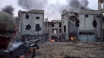 Movie still from “Full Metal Jacket” (1987), directed by Stanley Kubrick – An image of a person in a destroyed city; Extreme Wide shot, Low angle