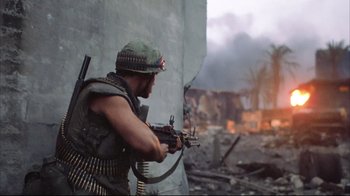 Movie still from “Full Metal Jacket” (1987), directed by Stanley Kubrick – A man with a rifle in a war zone; Medium shot, Low angle