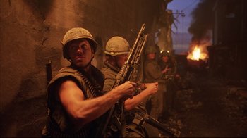 Movie still from “Full Metal Jacket” (1987), directed by Stanley Kubrick – A group of men standing next to each other holding guns; Medium shot, Over the shoulder angle