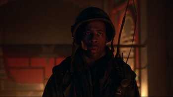 Movie still from “Full Metal Jacket” (1987), directed by Stanley Kubrick – A man wearing a helmet and a jacket; Close Up shot, Low angle