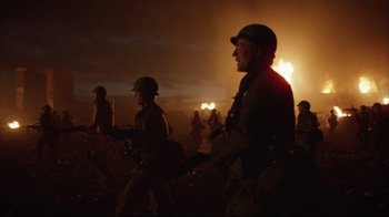 Movie still from “Full Metal Jacket” (1987), directed by Stanley Kubrick – A group of men walking across a field at night; Medium shot, Low angle