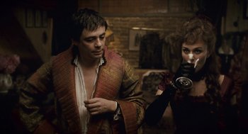 Movie still from “The Wolfman” (2010), directed by Joe Johnston – A man and a woman are standing in front of a camera; Medium shot, Over the shoulder angle