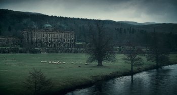Movie still from “The Wolfman” (2010), directed by Joe Johnston – A flock of sheep grazing on a lush green field; Extreme Wide shot, High angle