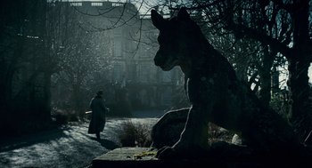 Movie still from “The Wolfman” (2010), directed by Joe Johnston – A statue of a dog in the middle of a park; Wide shot, Low angle