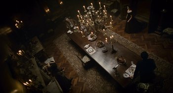 Movie still from “The Wolfman” (2010), directed by Joe Johnston – An overhead view of a dining room table with candles on it; Wide shot, High angle