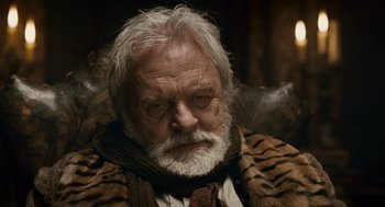 Movie still from “The Wolfman” (2010), directed by Joe Johnston – An old man with a beard and a tiger print jacket; Close Up shot, Low angle