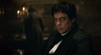 Movie still from “The Wolfman” (2010), directed by Joe Johnston – A person wearing a suit and tie; Close Up shot, Over the shoulder angle