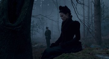 Movie still from “The Wolfman” (2010), directed by Joe Johnston – A man and a woman dressed in victorian clothing in the woods; Wide shot, High angle