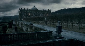 Movie still from “The Wolfman” (2010), directed by Joe Johnston – An old building with a fence in front of it; Extreme Wide shot, Low angle