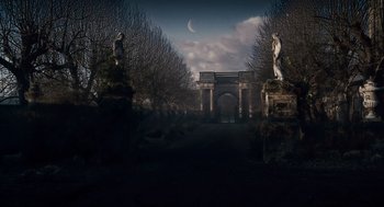 Movie still from “The Wolfman” (2010), directed by Joe Johnston – An image of an outdoor scene with statues and a moon in the background; Extreme Wide shot, High angle
