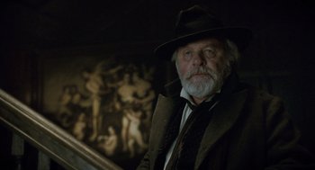 Movie still from “The Wolfman” (2010), directed by Joe Johnston – An old man with a beard wearing a hat; Close Up shot, Low angle