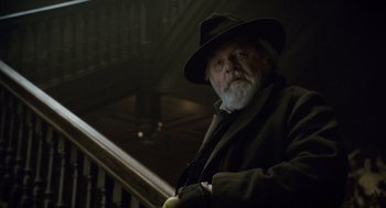 Movie still from “The Wolfman” (2010), directed by Joe Johnston – An old man with a beard wearing a hat; Close Up shot, Low angle