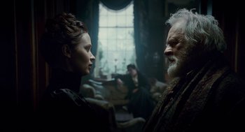 Movie still from “The Wolfman” (2010), directed by Joe Johnston – A woman and an older man in a room; Medium shot, Over the shoulder angle