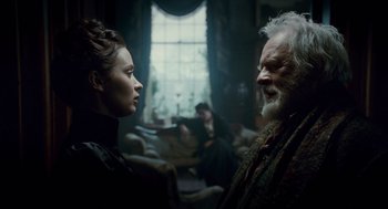 Movie still from “The Wolfman” (2010), directed by Joe Johnston – A man and a woman talking in a living room; Medium shot, Over the shoulder angle