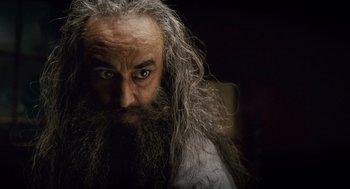 Movie still from “The Wolfman” (2010), directed by Joe Johnston – An old man with long grey hair and a long beard; Close Up shot, Low angle