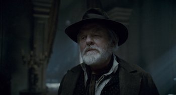Movie still from “The Wolfman” (2010), directed by Joe Johnston – An old man with a beard wearing a hat; Close Up shot, Low angle