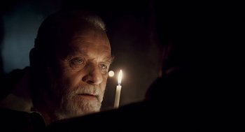 Movie still from “The Wolfman” (2010), directed by Joe Johnston – An old man looking at a candle in the dark; Close Up shot, Over the shoulder angle