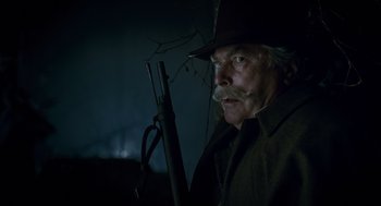 Movie still from “The Wolfman” (2010), directed by Joe Johnston – An older man with a mustache holding a rifle; Close Up shot, Low angle