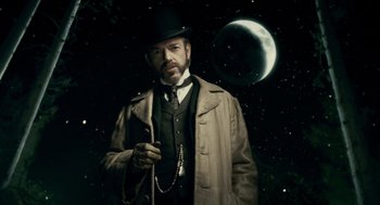 Movie still from “The Wolfman” (2010), directed by Joe Johnston – A man wearing a top hat and holding a whip; Medium shot, Low angle