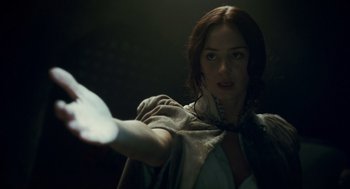Movie still from “The Wolfman” (2010), directed by Joe Johnston – A woman is holding a frisbee in a dark room; Close Up shot, Over the shoulder angle