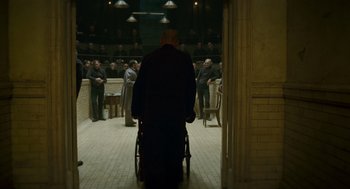 Movie still from “The Wolfman” (2010), directed by Joe Johnston – A man in a wheelchair in an empty room; Wide shot, High angle