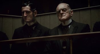 Movie still from “The Wolfman” (2010), directed by Joe Johnston – A man in a suit and tie next to another man in a suit and tie; Close Up shot, Low angle