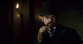 Movie still from “The Wolfman” (2010), directed by Joe Johnston – A person wearing a top hat; Close Up shot, Low angle