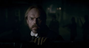 Movie still from “The Wolfman” (2010), directed by Joe Johnston – A man in a suit and tie looking at the camera; Close Up shot, Low angle