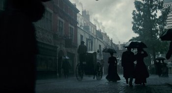 Movie still from “The Wolfman” (2010), directed by Joe Johnston – A group of people walking down a street with a horse and carriage; Wide shot, Low angle