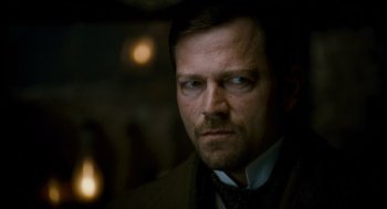 Movie still from “The Wolfman” (2010), directed by Joe Johnston – A person wearing a suit and tie; Close Up shot, Over the shoulder angle
