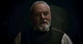 Movie still from “The Wolfman” (2010), directed by Joe Johnston – An old man with a beard and a white mustache; Close Up shot, Over the shoulder angle