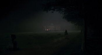 Movie still from “The Wolfman” (2010), directed by Joe Johnston – A person riding a bike in a field at night; Extreme Wide shot, Low angle