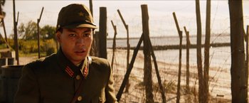Movie still from “The Wolverine” (2013), directed by James Mangold – A man in a military uniform standing next to a fence; Close Up shot, Low angle