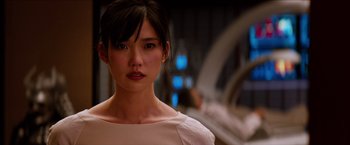 Movie still from “The Wolverine” (2013), directed by James Mangold – A young woman with bangs is looking at the camera; Close Up shot, Over the shoulder angle