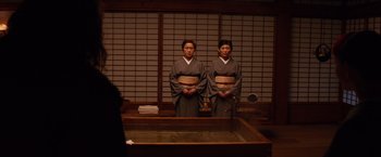 Movie still from “The Wolverine” (2013), directed by James Mangold – A couple of women standing next to each other in a room; Medium shot, High angle