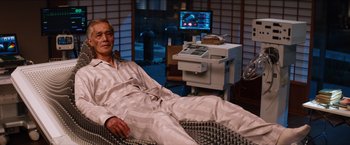 Movie still from “The Wolverine” (2013), directed by James Mangold – A man sitting in a chair in a room; Medium shot, High angle