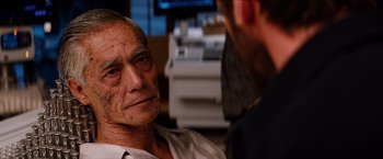Movie still from “The Wolverine” (2013), directed by James Mangold – An older man sitting in front of another man in front of a computer monitor; Close Up shot, Over the shoulder angle