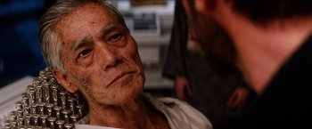 Movie still from “The Wolverine” (2013), directed by James Mangold – An old man with a white shirt is looking at the camera; Close Up shot, Over the shoulder angle
