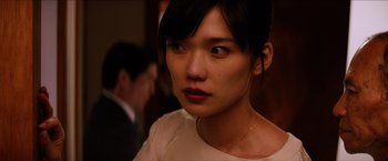 Movie still from “The Wolverine” (2013), directed by James Mangold – A person wearing a white shirt; Close Up shot, Over the shoulder angle