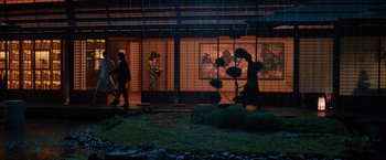 Movie still from “The Wolverine” (2013), directed by James Mangold – Two people walking in front of a building at night; Extreme Wide shot, Low angle