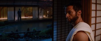 Movie still from “The Wolverine” (2013), directed by James Mangold – A man standing in front of a building at night; Close Up shot, Over the shoulder angle
