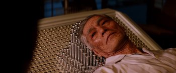 Movie still from “The Wolverine” (2013), directed by James Mangold – An older man laying on top of a table; Close Up shot, Overhead angle