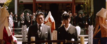 Movie still from “The Wolverine” (2013), directed by James Mangold – A man and a woman standing next to each other; Medium shot, Low angle