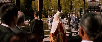 Two people dressed up in costumes near a pond