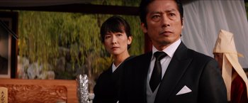 Movie still from “The Wolverine” (2013), directed by James Mangold – A man and a woman wearing suits and ties; Close Up shot, Low angle