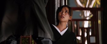 Movie still from “The Wolverine” (2013), directed by James Mangold – A young woman in a black kimono looking up; Medium shot, Over the shoulder angle
